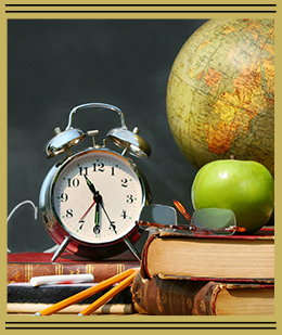 a clock, apple and globe all sitting on a stack of books